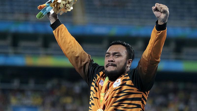 Gold medalist Muhammad Ziyad Zolkefli of Malaysia celebrate on the podium at the medal ceremony for the Men's Shot Put F20 Final at the Rio 2016 Paralympic Games.